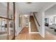 Bright entryway featuring hardwood floors, staircase, and stylish decor at 2802 Ion Ave, Sullivans Island, SC 29482