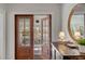 Warm and inviting foyer offering a sneak peek of the outdoor porch through wood framed glass paneled doors at 2802 Ion Ave, Sullivans Island, SC 29482