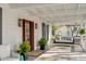 Cozy front porch with a swing, rocking chairs, and charming outdoor decor at 2802 Ion Ave, Sullivans Island, SC 29482