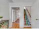 Bright hallway leading to stairs with striped carpet at 2802 Ion Ave, Sullivans Island, SC 29482