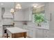 Lovely kitchen featuring marble countertops, a center island, and stainless steel appliances at 2802 Ion Ave, Sullivans Island, SC 29482