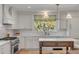 Well-lit kitchen with island, marble countertops, and a window that lets in natural light at 2802 Ion Ave, Sullivans Island, SC 29482
