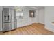 Kitchenette featuring stainless steel refrigerator, white cabinets, and laminate flooring at 2802 Ion Ave, Sullivans Island, SC 29482