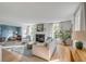 Bright living room with a fireplace, white sofa, and view into a sitting room at 2802 Ion Ave, Sullivans Island, SC 29482