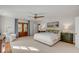 Spacious bedroom with wood floors, French doors, ceiling fan, and ample natural light at 2802 Ion Ave, Sullivans Island, SC 29482