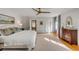 Bright main bedroom with hardwood floors, neutral walls, a ceiling fan, and ample closet space at 2802 Ion Ave, Sullivans Island, SC 29482