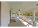 Relaxing porch with a ceiling fan, views of the trees, and a spacious seating area at 2802 Ion Ave, Sullivans Island, SC 29482