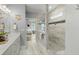 Bright bathroom with double sinks, a glass shower, and a view into the Primary bedroom at 282 Great Lawn Dr, Summerville, SC 29486
