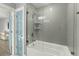 Modern bathroom featuring a tub/shower combination with glass door and bright blue door to the hall at 282 Great Lawn Dr, Summerville, SC 29486