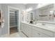 Bathroom features a double vanity, a large mirror, and access to an organized walk-in closet at 282 Great Lawn Dr, Summerville, SC 29486