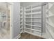 Walk-in closet with built-in shelves leading to a bathroom with a tiled shower at 282 Great Lawn Dr, Summerville, SC 29486