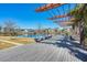 Scenic view from a wooden deck overlooking a pond with a pergola and bench in a Primary-planned community at 282 Great Lawn Dr, Summerville, SC 29486