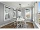 Bright dining room with plenty of natural light from the surrounding windows at 282 Great Lawn Dr, Summerville, SC 29486