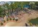 Aerial view of the community dog park surrounded by lush trees and vegetation adjacent to a pond at 282 Great Lawn Dr, Summerville, SC 29486