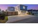 A two-car garage with a driveway, a fenced yard, a stairway entrance, and minimal landscaping at 282 Great Lawn Dr, Summerville, SC 29486