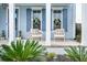 Close up of the front porch with rocking chairs and blue accents at 282 Great Lawn Dr, Summerville, SC 29486
