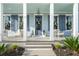Charming front porch with white columns, seating, and blue accents at 282 Great Lawn Dr, Summerville, SC 29486