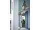 Close up of front porch showing white columns, window, and blue shutters at 282 Great Lawn Dr, Summerville, SC 29486