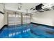 Spacious two-car garage featuring a blue epoxy floor and two white paneled garage doors at 282 Great Lawn Dr, Summerville, SC 29486