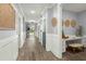Hallway with hardwood floors, white trim, and a built-in desk area, blending functionality with stylish design at 282 Great Lawn Dr, Summerville, SC 29486