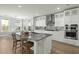 Modern kitchen features an island with seating, stainless steel appliances, and custom cabinetry at 282 Great Lawn Dr, Summerville, SC 29486