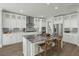 Modern kitchen features an island with seating, stainless steel appliances, and custom cabinetry at 282 Great Lawn Dr, Summerville, SC 29486