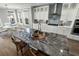 Bright and airy kitchen island with stone countertops, stainless faucet and seating at 282 Great Lawn Dr, Summerville, SC 29486