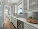 Bright kitchen featuring white cabinetry, quartz countertops and under cabinet beverage fridge at 282 Great Lawn Dr, Summerville, SC 29486