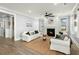 Bright living room boasts a fireplace, ceiling fan, and ample seating with large windows at 282 Great Lawn Dr, Summerville, SC 29486