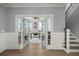 Entry to an office with open doors, hardwood floors, and a staircase, creating a seamless transition between spaces at 282 Great Lawn Dr, Summerville, SC 29486