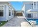Light blue patio area with large stone pavers, access to a covered area, and partially shaded pool area at 282 Great Lawn Dr, Summerville, SC 29486