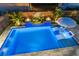 A stunning, modern pool with unique features like fire bowls and an umbrella table with seating at 282 Great Lawn Dr, Summerville, SC 29486