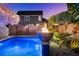 Lovely pool with fire bowls, tropical plants, and a privacy fence providing an intimate atmosphere at 282 Great Lawn Dr, Summerville, SC 29486