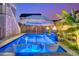 A stylish pool featuring in-pool seating, an umbrella table, and elegant fire bowls for a relaxed ambiance at 282 Great Lawn Dr, Summerville, SC 29486