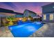 Private backyard pool oasis featuring fire bowls, tropical landscaping, and comfortable tanning ledge at 282 Great Lawn Dr, Summerville, SC 29486