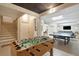 Recreational basement space features a foosball table and stairs to a room with ping pong and tv at 3 37Th Ave, Isle of Palms, SC 29451