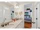 Bright bathroom with granite counters, double sinks, and access to the bedroom at 3 37Th Ave, Isle of Palms, SC 29451