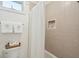 Clean bathroom featuring white tiles, modern fixtures, and convenient storage niche at 3 37Th Ave, Isle of Palms, SC 29451