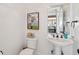 Charming powder room featuring a pedestal sink and a white paneled wall at 3 37Th Ave, Isle of Palms, SC 29451
