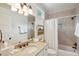 Well-lit bathroom features a granite countertop vanity and a shower-tub combo for convenience at 3 37Th Ave, Isle of Palms, SC 29451