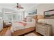 Bright bedroom boasts a wicker bed frame, balcony access, and coastal decor for a serene retreat at 3 37Th Ave, Isle of Palms, SC 29451