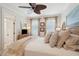 Bright bedroom with a wicker bed frame, wood floors, ceiling fan and light colored walls at 3 37Th Ave, Isle of Palms, SC 29451