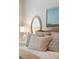 Close up of a bedroom highlighting the bed pillows, headboard and wall decor at 3 37Th Ave, Isle of Palms, SC 29451