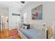 Bright bedroom with a daybed featuring blue patterned bedding and an adjacent ensuite bathroom at 3 37Th Ave, Isle of Palms, SC 29451