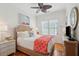 Comfortable bedroom features a wicker bed frame, ceiling fan, and a light and bright atmosphere at 3 37Th Ave, Isle of Palms, SC 29451