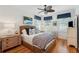 Bedroom with a wicker frame bed, hardwood floors, ceiling fan and blue accents at 3 37Th Ave, Isle of Palms, SC 29451