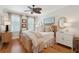Cozy bedroom featuring a wicker bed, ceiling fan, wood floors, and soft, neutral decor at 3 37Th Ave, Isle of Palms, SC 29451