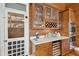 Butler pantry area with wine storage, glass cabinets, marble countertop, and stainless ovens at 3 37Th Ave, Isle of Palms, SC 29451