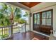 Welcoming front porch with double doors offering a view of palm trees and the neighborhood at 3 37Th Ave, Isle of Palms, SC 29451