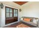 Inviting front porch with double doors, a wooden bench, throw pillows, and decorative lanterns at 3 37Th Ave, Isle of Palms, SC 29451